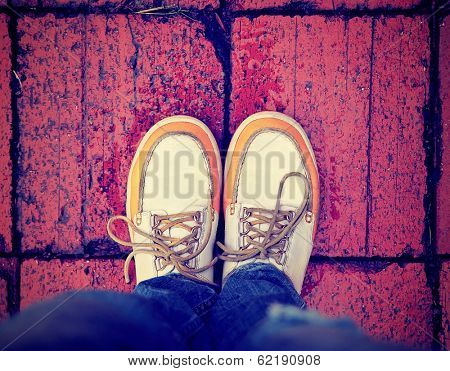 a shot of yellow and white boat or deck shoes done with a retro vintage instagram filter 