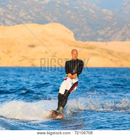 Wakeboarder in sunset.