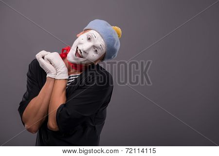 Portrait of young mime boy showing something with his hands