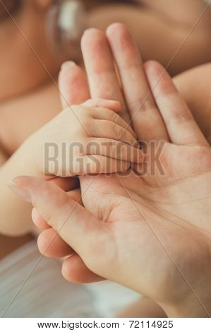 small child holding the handle of the mother