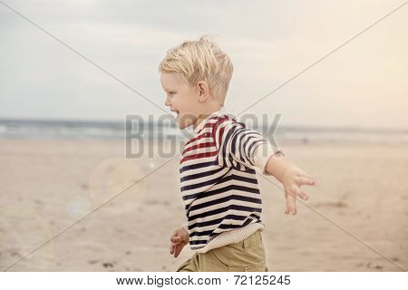 happy kid running on the sea beach