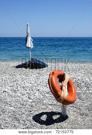 stil-life with lifebuoy and beach umbrella