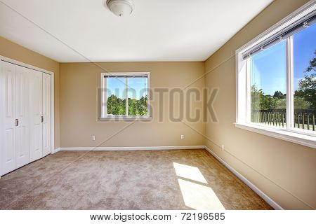 Empty House. Room With Carpet Floor In Soft Beige Color