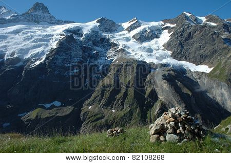 Cairn And Peaks In Snow Nearby Grindelwald In Switzerland