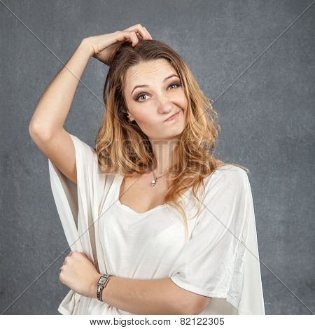 Puzzled Woman With Hands In Her Hair