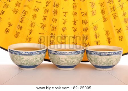 Still life of tea crockery and hand fan