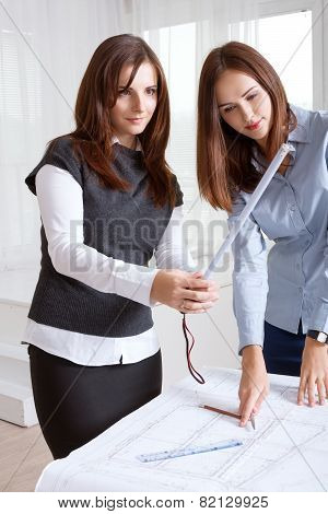 Female Architects Studying Blueprints