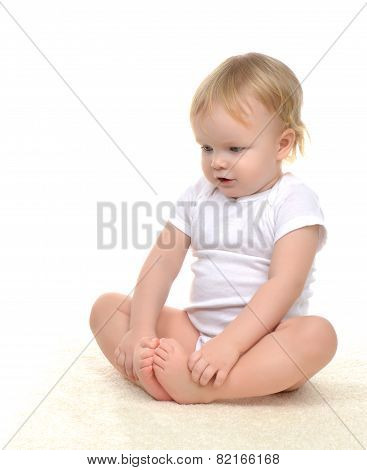 Infant Child Baby Toddler Kid Sitting On Carpet And Looking Down