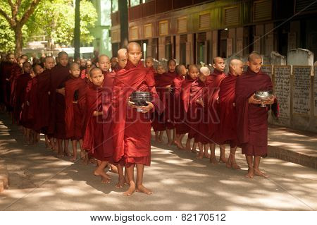 Row Of Buddhist Monks Waiting Lunch.