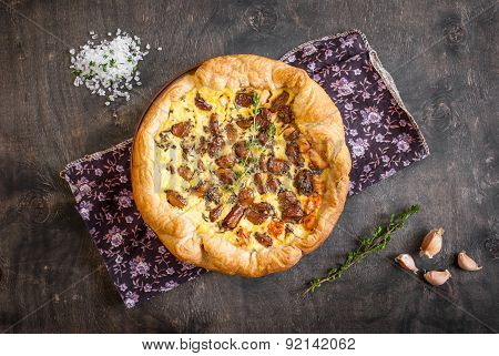 Caramelized Garlic Tart With Goat Cheese On Dark Wooden Background