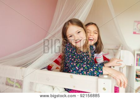 Two little girls playing in their room