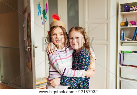Two little girls playing in their room