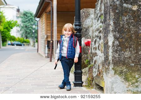 Young boy with backpack ready to go back to school