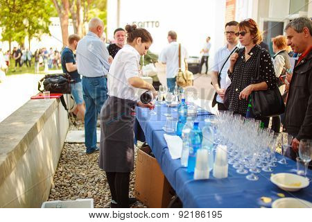 Waiter Pours A Drink