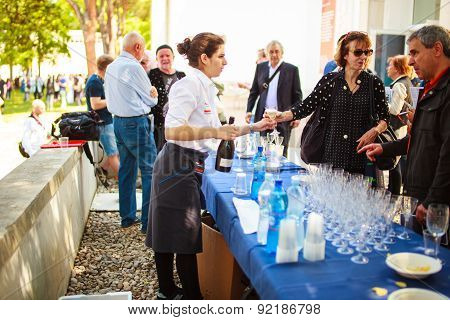 Waiter Pours A Drink