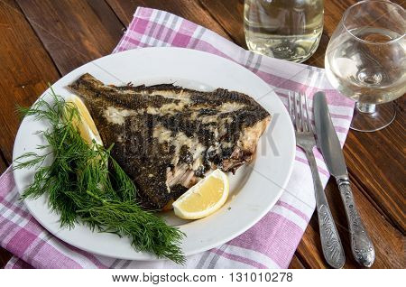 grilled flounder fish on the white plate