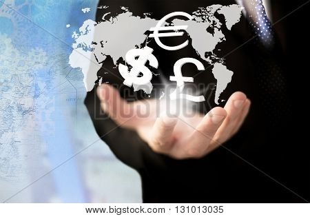 Investment concept. Businessman holding world currency symbols.
