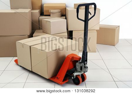 Manual pallet truck with carton boxes indoors