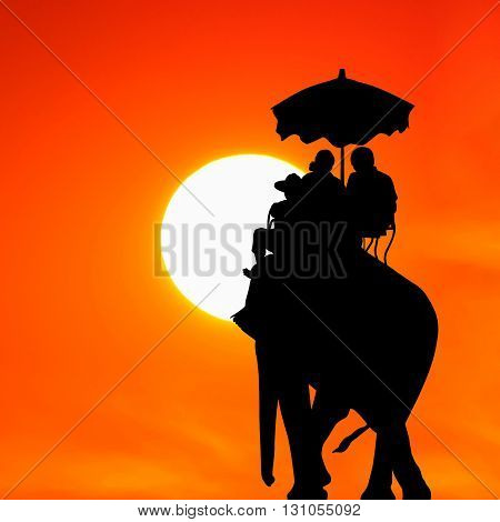 silhouette elephant with tourist at beautiful sunset
