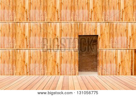 wooden wall with door and wood floor in front off