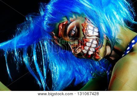 Fashionable zombie girl. Portrait of a pin-up zombie woman. Body-painting project. Halloween make-up. Horror.
