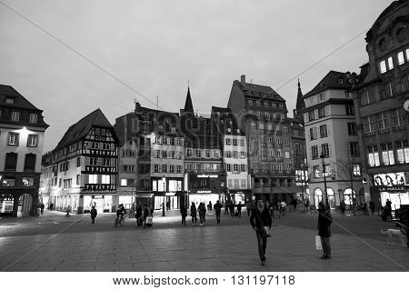STRASBOURG FRANCE - MAR 24 2016: Place Kleber UNESCO World Heritage site in central Strasbourg with tourist admiring the city at the evening