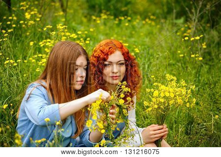 Best friends forever. Girlfriends collect bouquets of wildflowers. BFF.