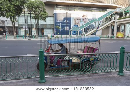 BANGKOK THAILAND - APR 17 : tuktuk is parking in front of CentralWorld on Ratchaprasong road on april 17 2016 thailand. tuktuk is popular taxi service of tourists in bangkok