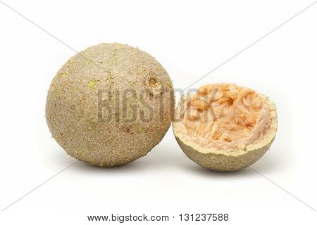 A whole and A half cracked Organic Limonia or Kaitha (Limonia acidissima) isolated on white background.