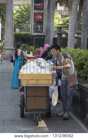 BANGKOK THAILAND - APR 24 : fresh coconut juice stall in Ratchaprasong Junction in front of CentralWorld on april 24 2016 thailand. Ratchaprasong Junction one of is famous landmark of Bangkok