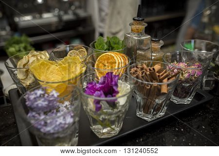 Background of bar: orange , cinnamon sticks, hazelnuts, lemon and on table.