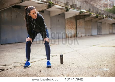 Young runner making a break after great exercise.