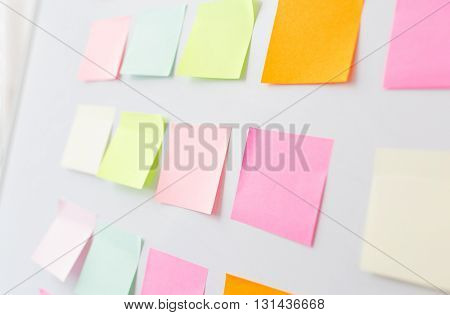 business, information, memo, management and education concept - close up of blank paper stickers on white board