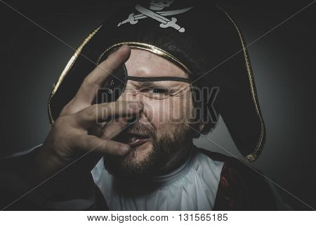 Derision. man pirate with eye patch and old hat with funny faces and expressive