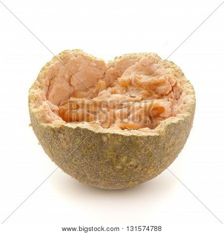 One half of a cracked Organic Limonia or Kaitha (Limonia acidissima) isolated on white background.