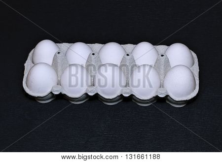 Fresh chicken eggs closeup on a black background