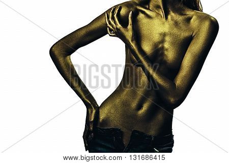 Golden female body of young sexy beautiful woman with bare chest and belly isolated on white background. Metalic art body art