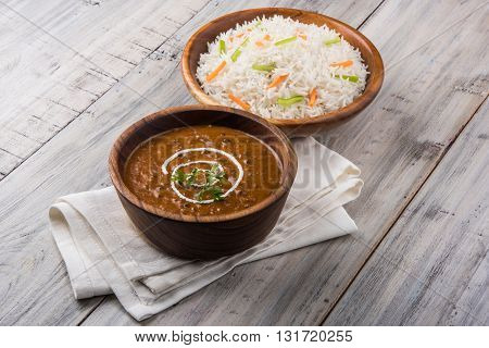 dal makhani or daal makhani or dal makhni with plain basmati rice, served in wooden bowl