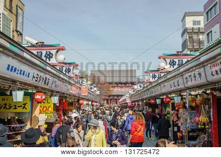 TOKYO,JAPAN - 24 November  2015 :Tourists walk on Nakamise Dori in Sensoji shrine.Sensoji temple with a variety of traditional, local snacks and tourist souvenirs for centuries.