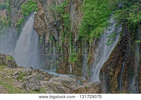 Kapuzbashi Waterfalls surrounded with bright green foliage. Turkey Aladaglar Mountains.