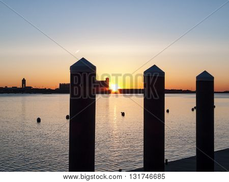 View from Fan Pier of sun rising over Logan Airport in Boston Massachusetts