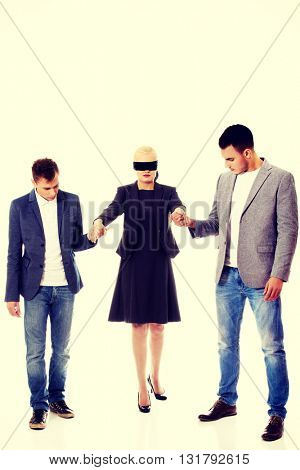 Business team-two men helping to blindfolded woman