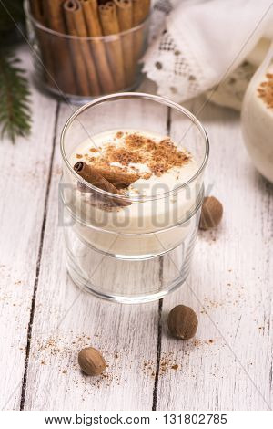 Winter warm milk drink eggnog with cinnamon and nutmeg. Selective focus