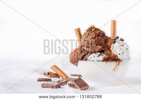 Chocolate and cookies ice cream on rustic background