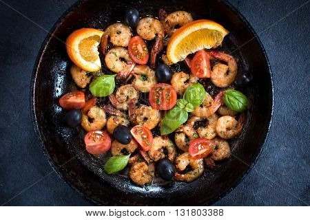 Fried shrimps in pan on rustic background