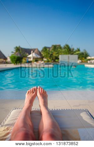 Close up of female feet on white sandy beach