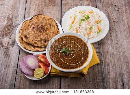 Dal makhani or dal makhni a Buttery Lentils made up of black gram, served with indian bread or chapati and rice