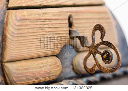 Old wooden trunk with metal elements isolated on white background close up slective focus