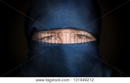 Eyes Of Young Woman Veiled With Blue Niqab Scarf. Low Key Photo.