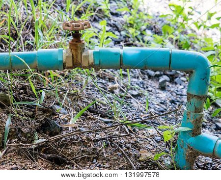 Small pvc pipe with old steel valve for ountryside farm.